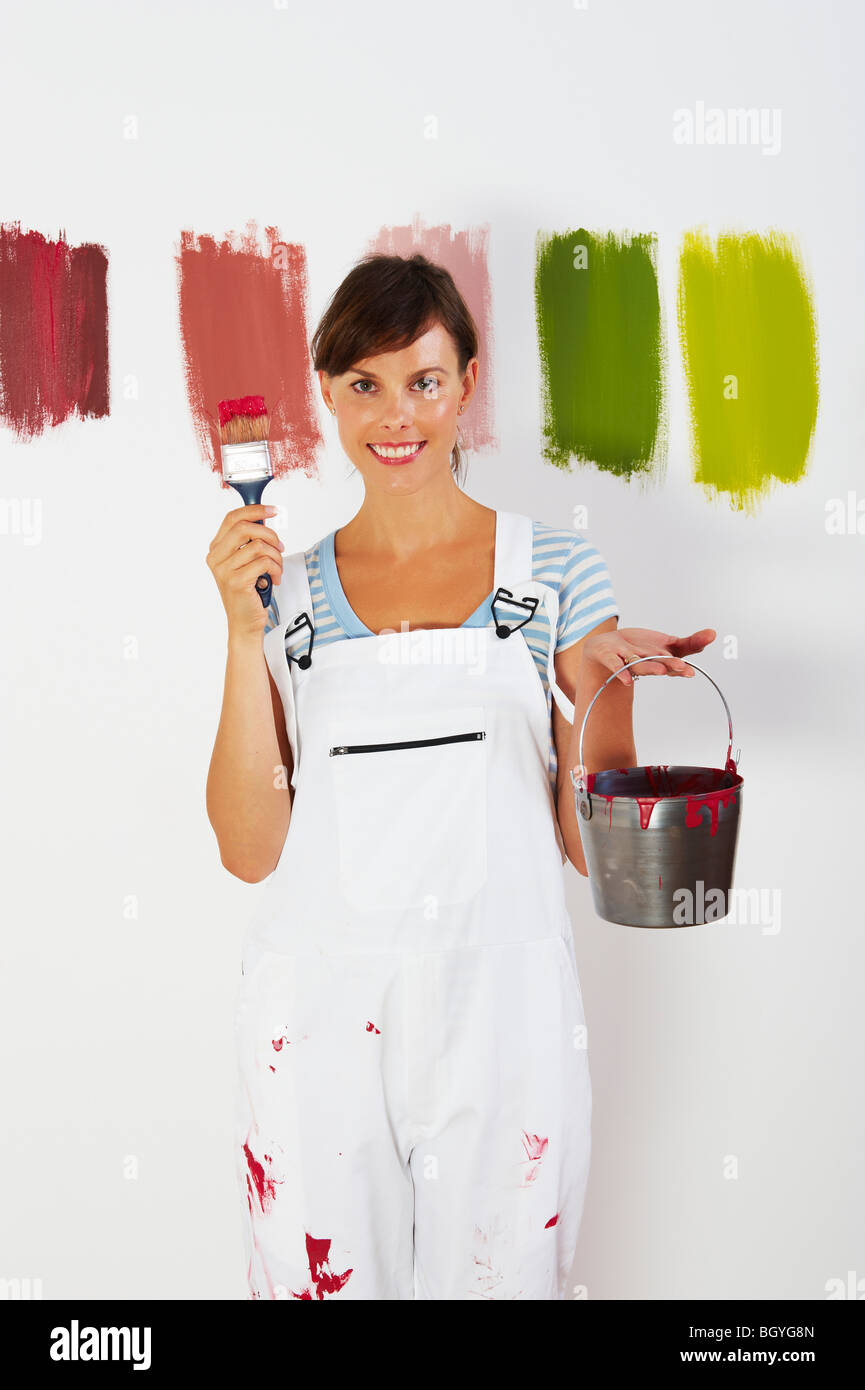 Woman holding paint brush and bucket Stock Photo