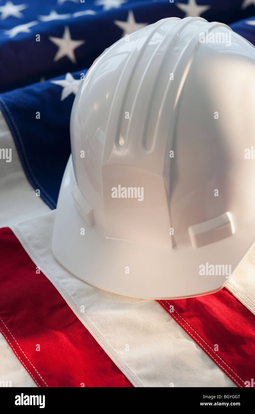 Hard hat on top of American flag Stock Photo