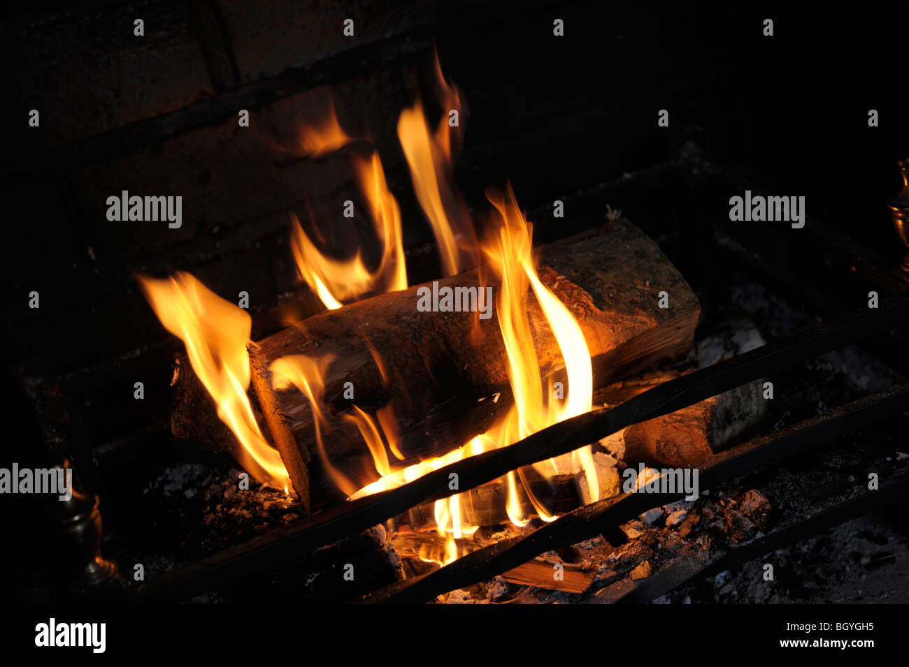 Burning logs in a fire basket Stock Photo Alamy