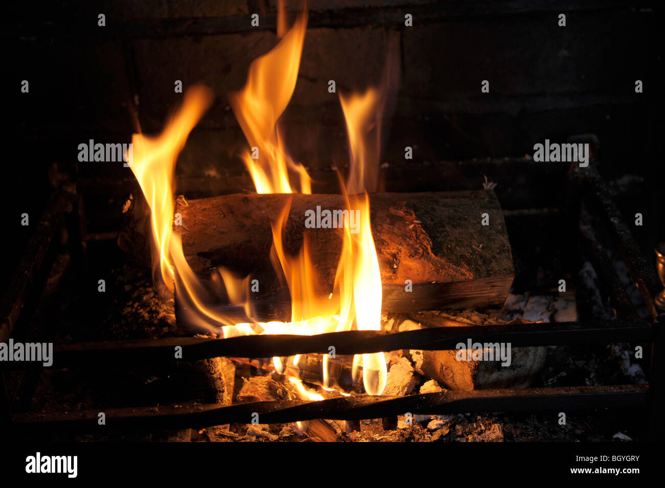 Burning logs in a fire basket Stock Photo Alamy