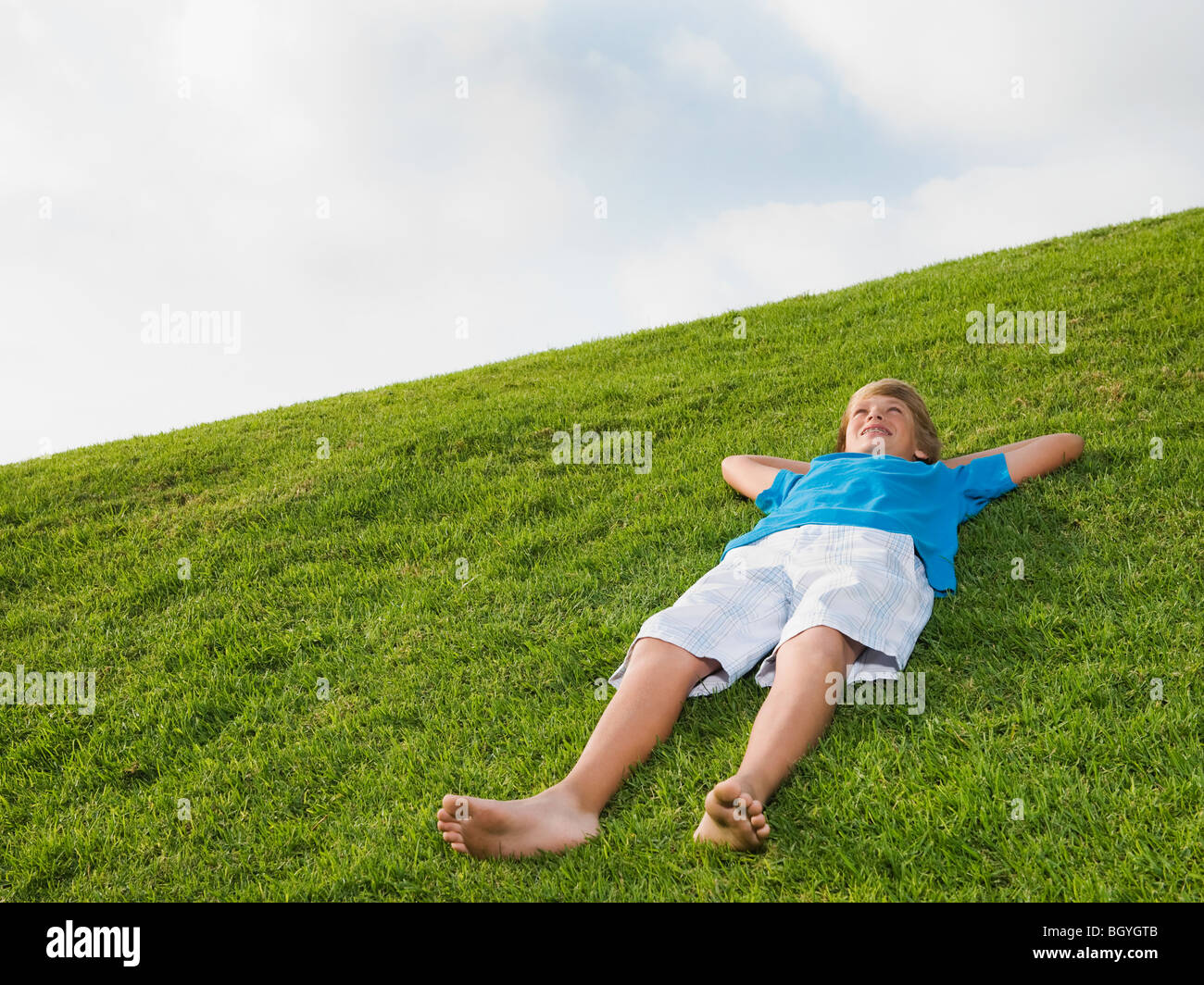 Boy resting on grass Stock Photo