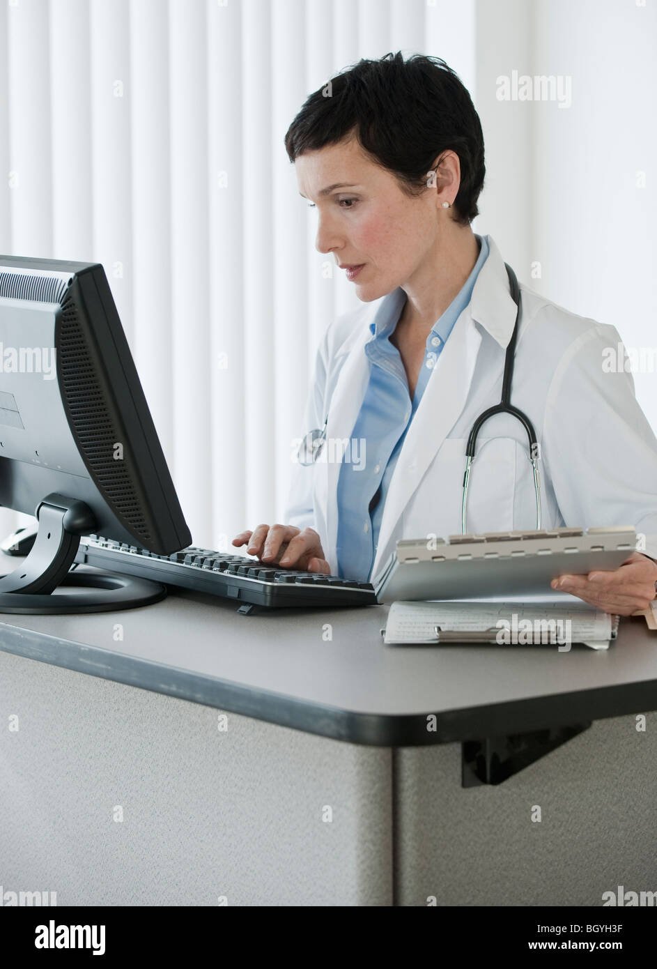 Doctor working on computer Stock Photo