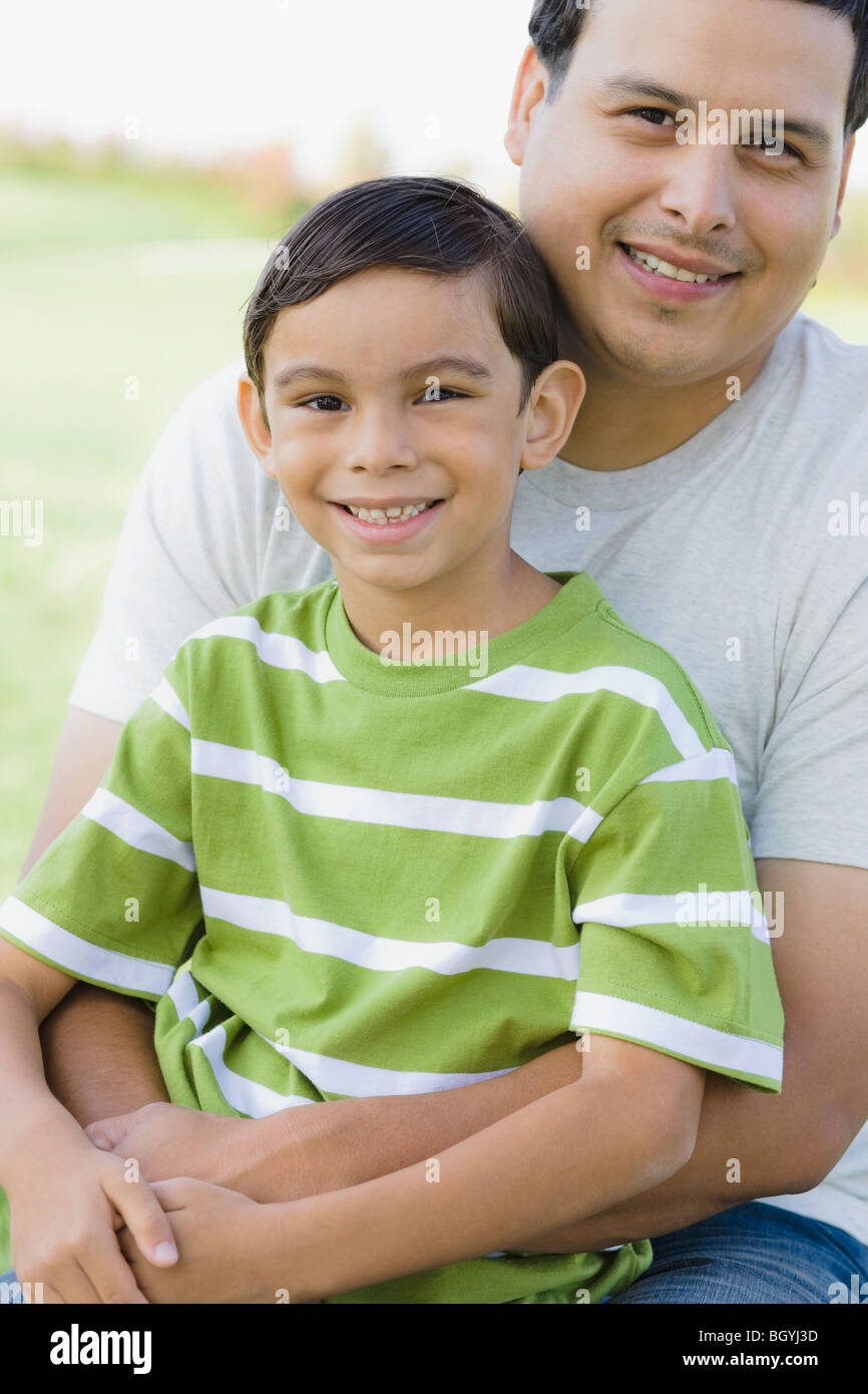 Boy sitting on fathers lap hi-res stock photography and images - Alamy
