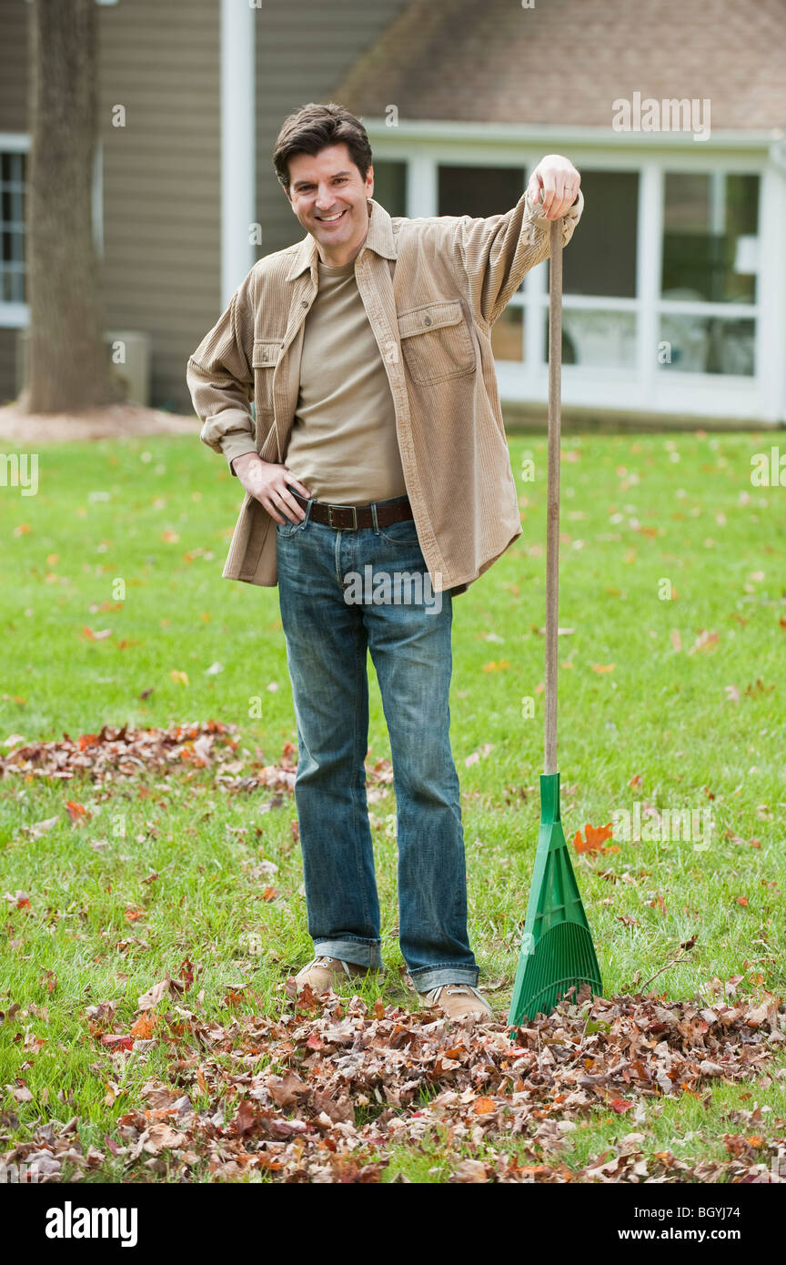 Man raking leaves Stock Photo Alamy