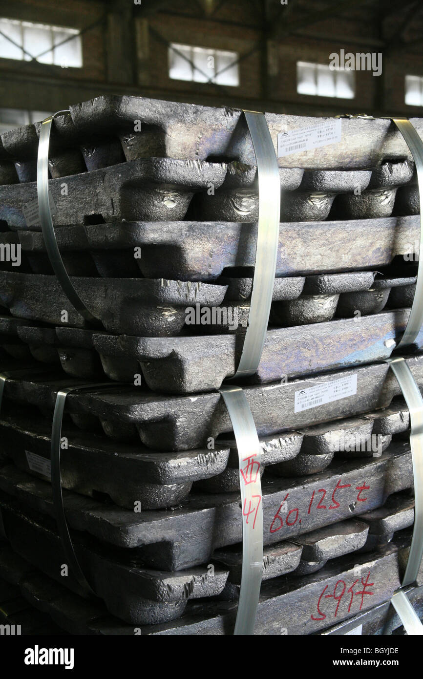 Lead metal ingots stacked up in a Chinese warehouse Stock Photo