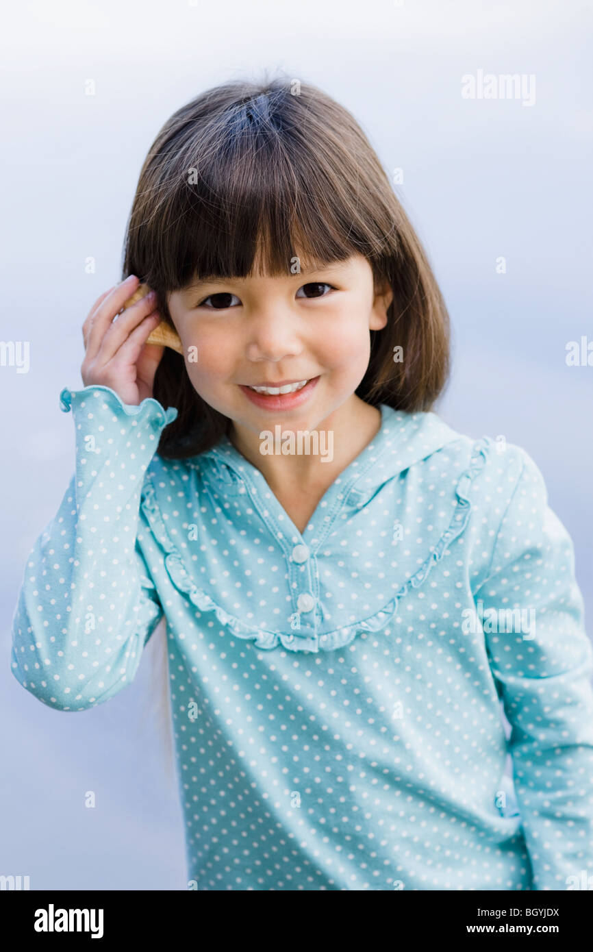 Young girl holding seashell Stock Photo