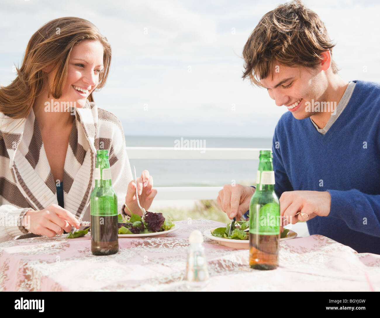 Couple eating at the beach Stock Photo
