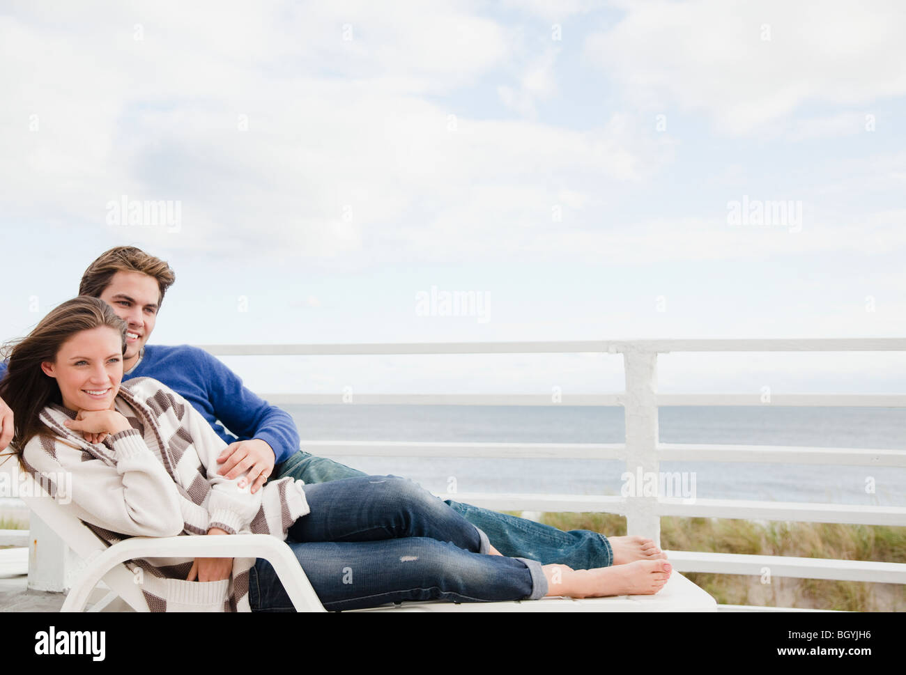 Young Couple Relaxing On Chairs High Resolution Stock Photography and ...
