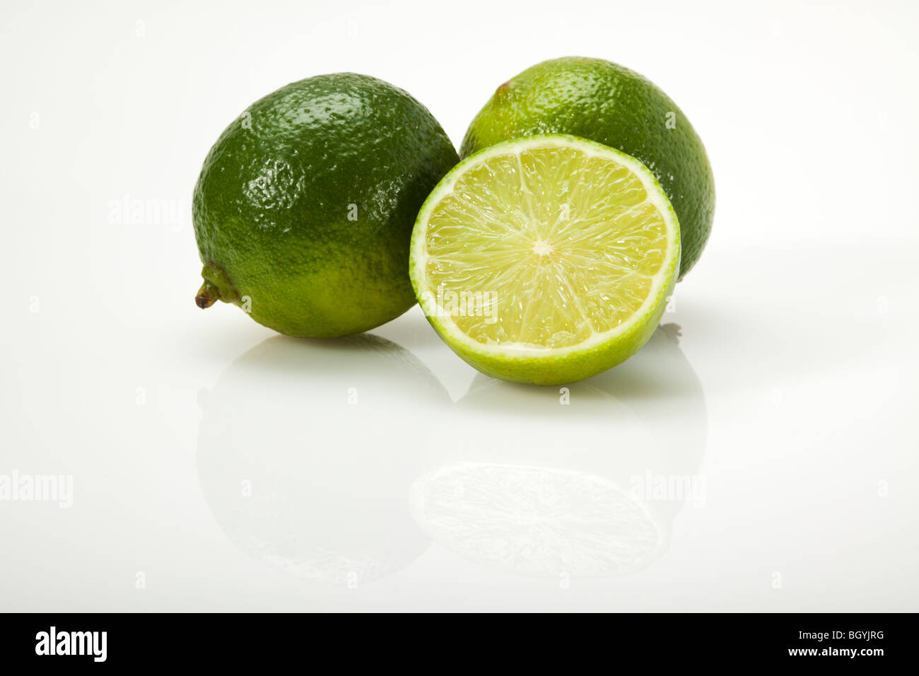 two and a half lime fruit on white surface Stock Photo