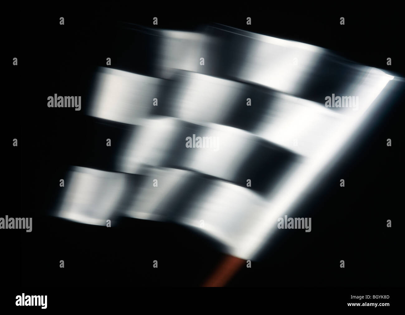 Chequered flag with Movement on a Black Background Stock Photo