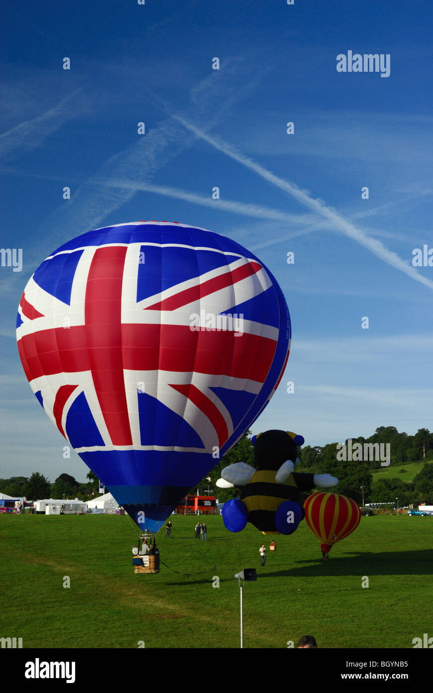 Union Flag and Bumble bee novelty Hot Air Balloons at Bristol International Balloon fiesta on a bright sunny day in 2009 Stock Photo