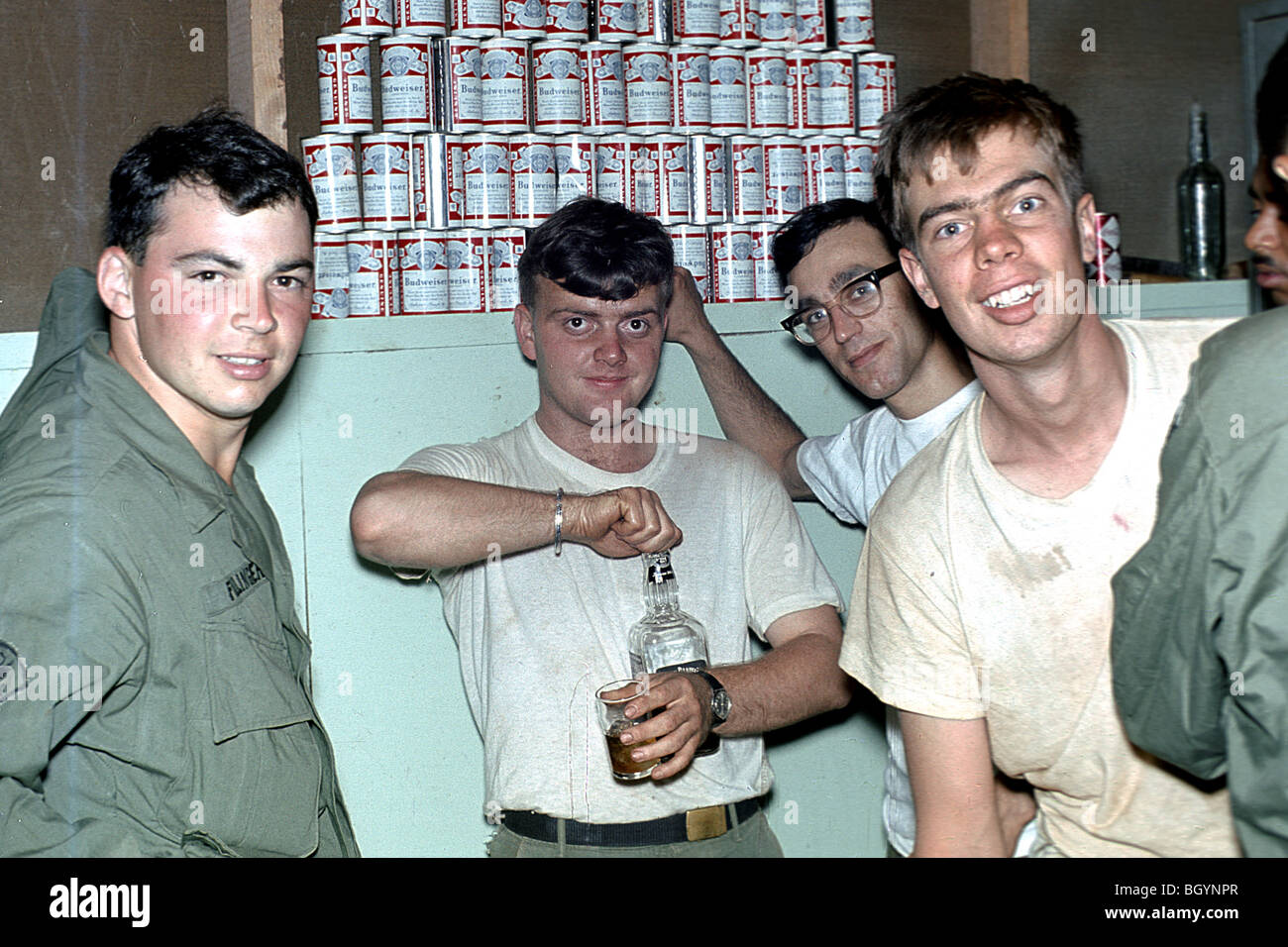 Teenagers and twenties GIs getting drunk with stack of budweiser beers cans. 4th Infantry Division Ivy in Pleiku Province 1968. Stock Photo