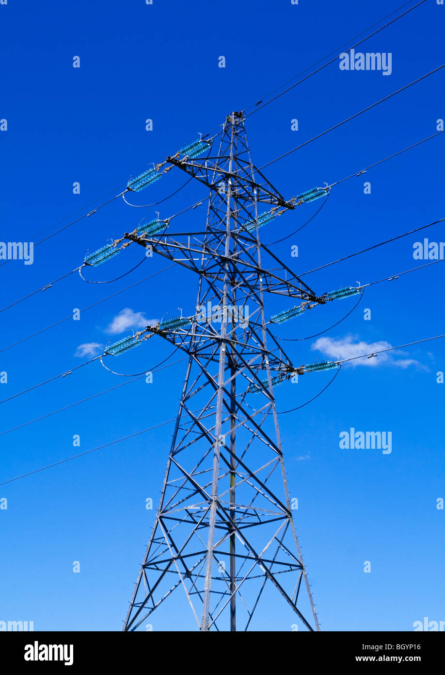 Electricity pylon with blue sky and small white clouds behind Stock ...