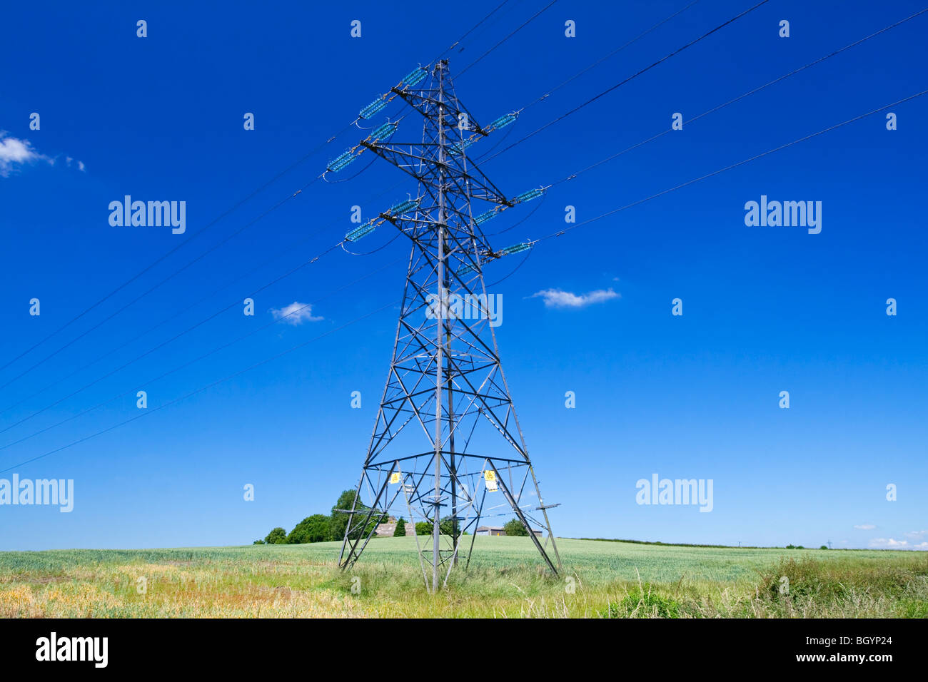 Electricity pylon with blue sky and small white clouds behind Stock ...