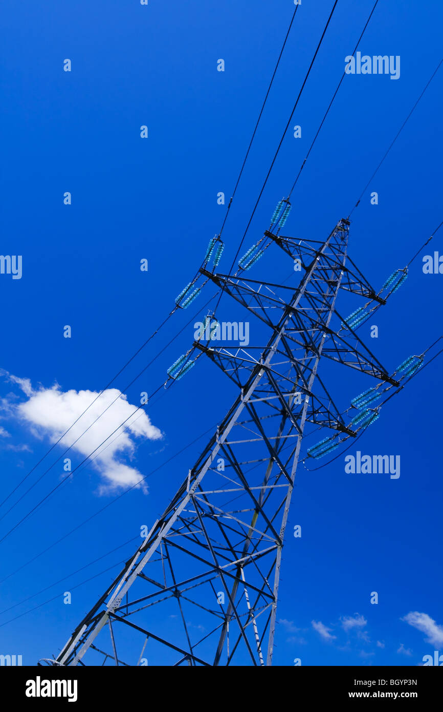 Electricity pylon with blue sky and small white clouds behind Stock ...