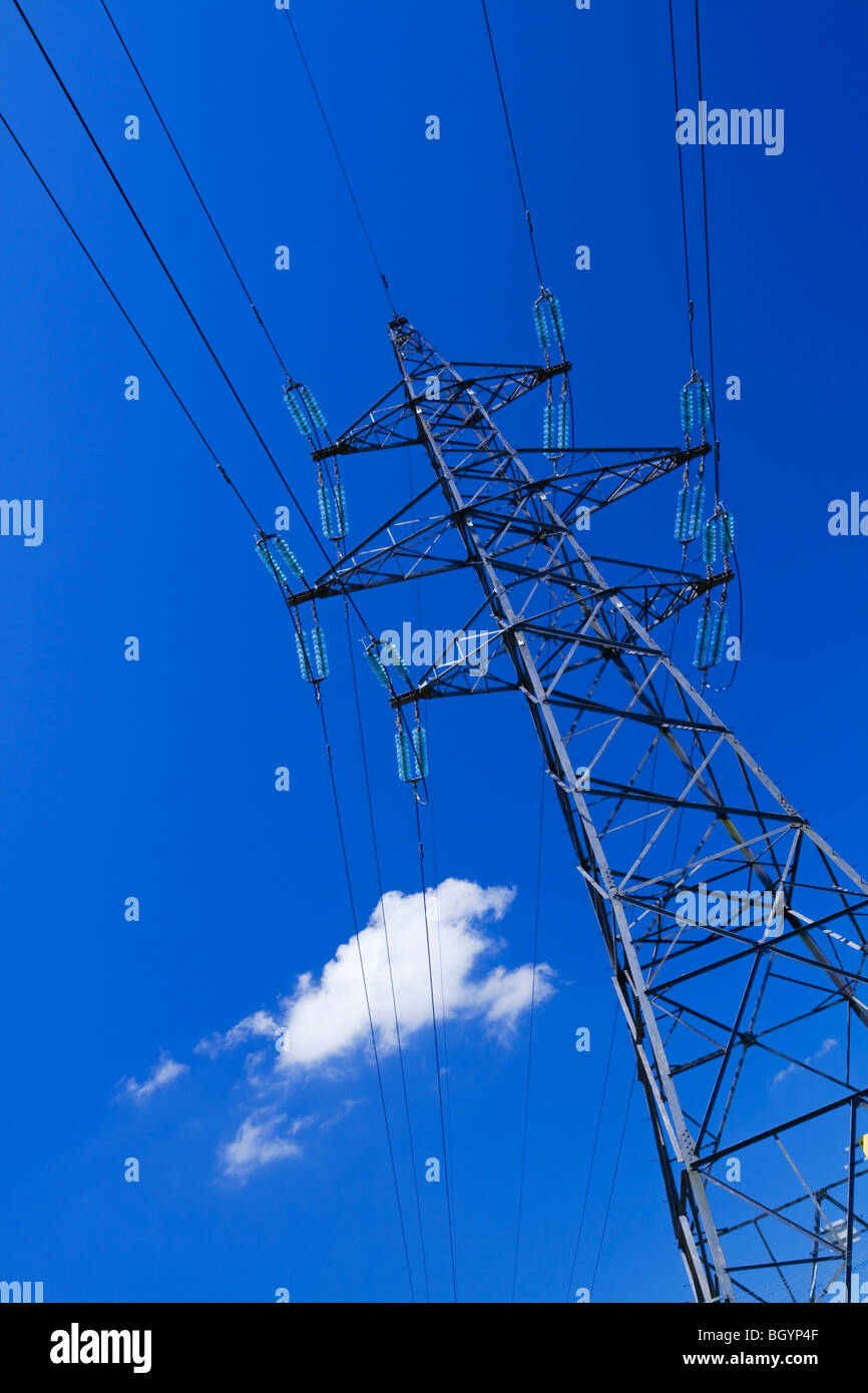 Electricity pylon with blue sky and small white clouds behind Stock ...