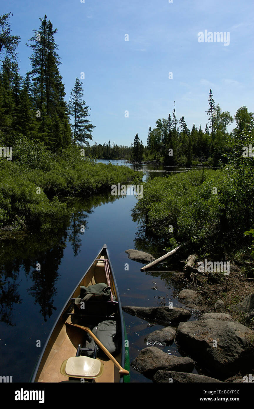 Canoe in stream at a portage in the Boundary Waters Canoe Area Wilderness Stock Photo