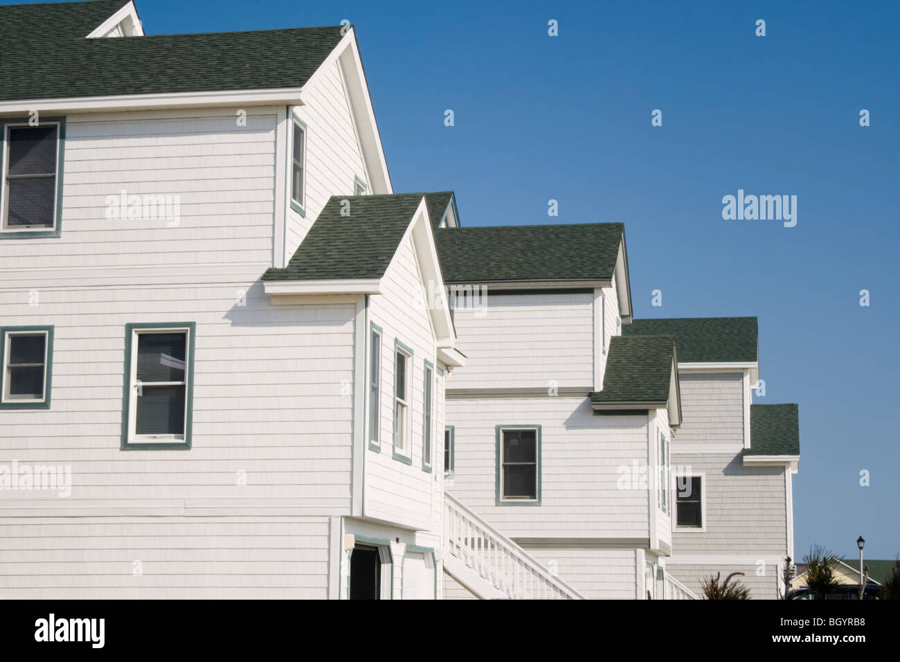 Roofs in summer sun on new town houses in a row. Stock Photo