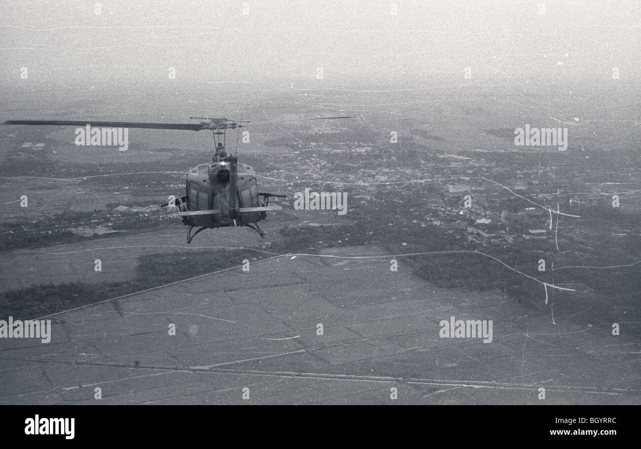 A helicopter of the 121st AHC out of Soc Trang, Vietnam, flies on a mission during the Vietnam War. Stock Photo