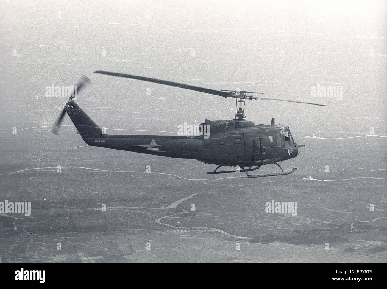 A helicopter of the 121st AHC out of Soc Trang, Vietnam, flies on a mission during the Vietnam War. Stock Photo