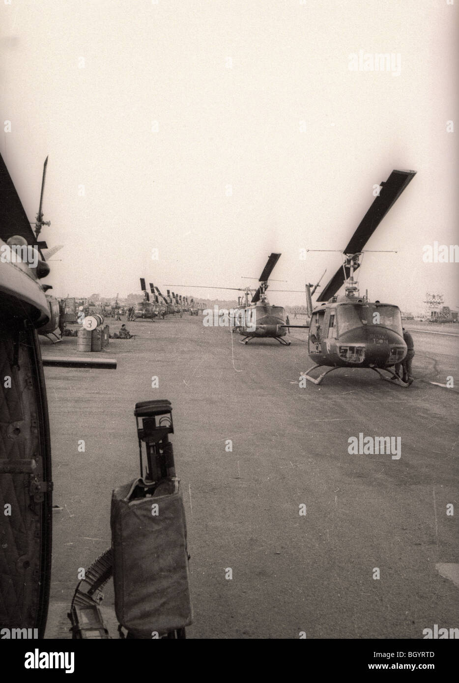 Huey helicopters of the 121st AHC out of Soc Trang, Vietnam, wait on a flight line for a mission during the Vietnam War. Stock Photo