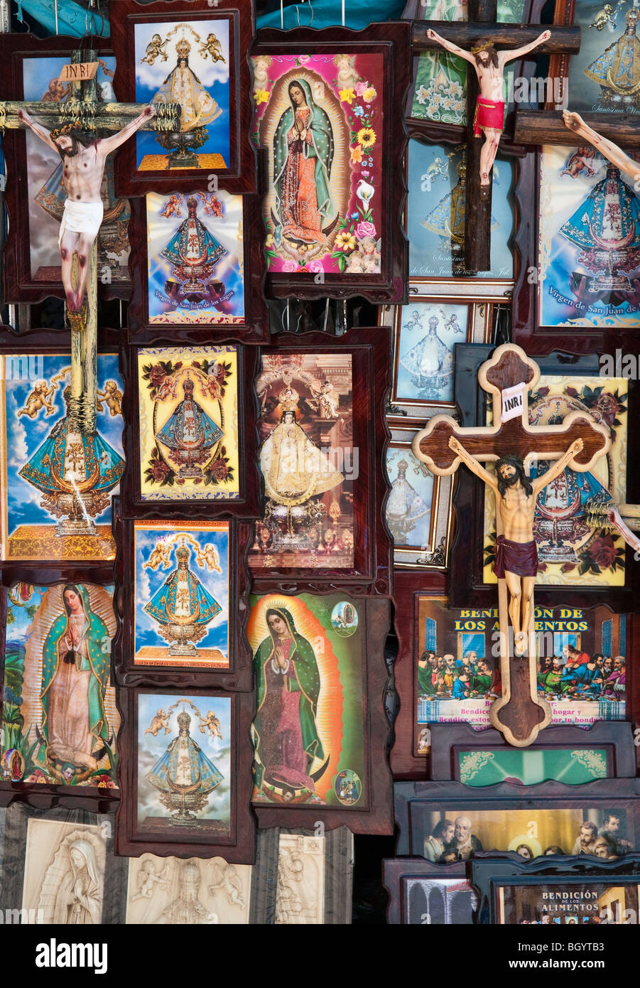 Religious paintings and Christ on the cross figurines for sale in the town of San Juan de los Lagos, Jalisco, Mexico. Stock Photo