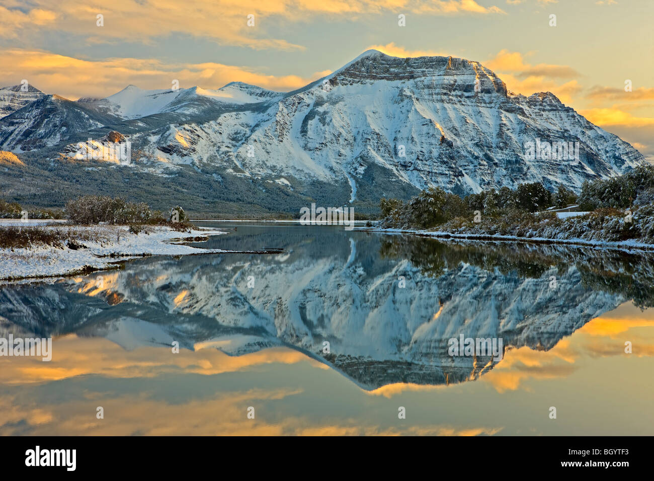 Reflections of Mt Vimy on Lower Waterton Lake (Knight's Lake) at sunset in Waterton Lakes National Park (a UNESCO World Heritage Stock Photo