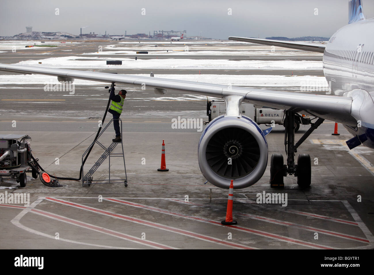 Man refueling a plane, Logan International Airport, Boston, Massachusetts Stock Photo