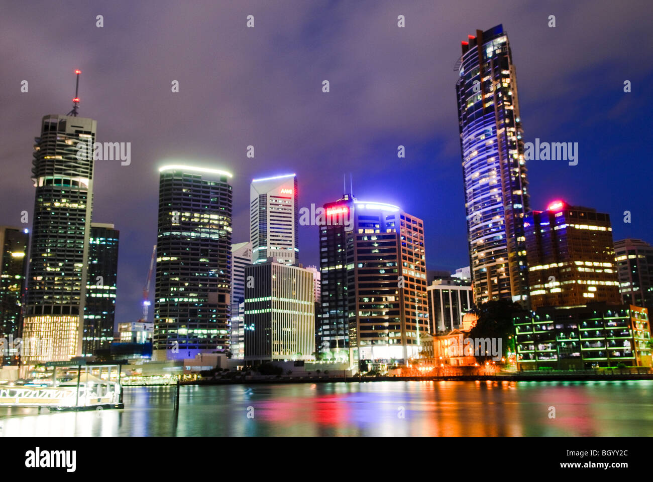 BRISBANE, Australia — The Brisbane CBD city skyline at night, as seen from across the Brisbane River at Captain Burke Park. The illuminated high-rise buildings reflect off the calm waters of the river, creating a stunning view of the city’s vibrant downtown. Stock Photo