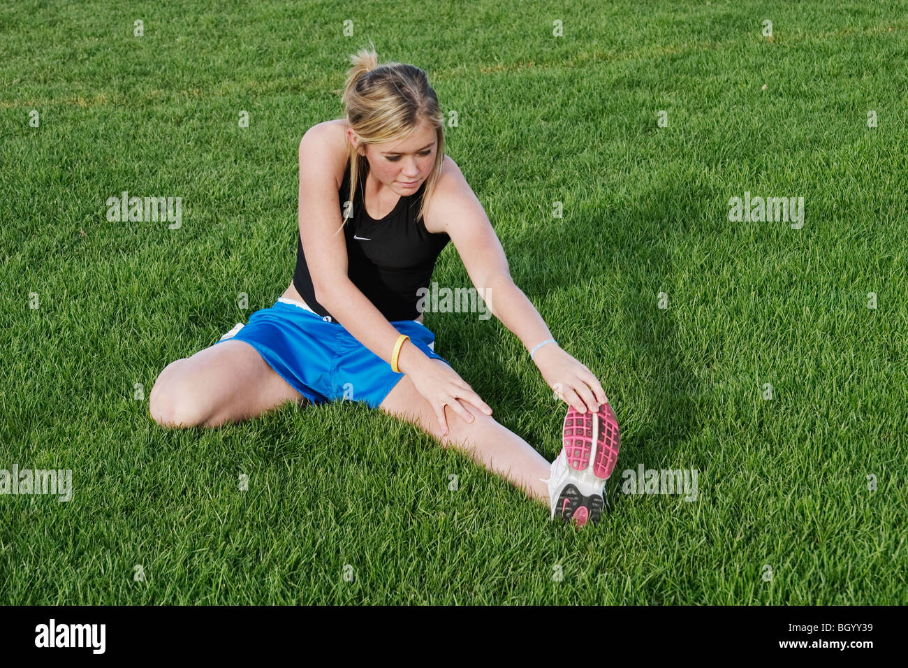 Teen girl stretching before running track Stock Photo Alamy