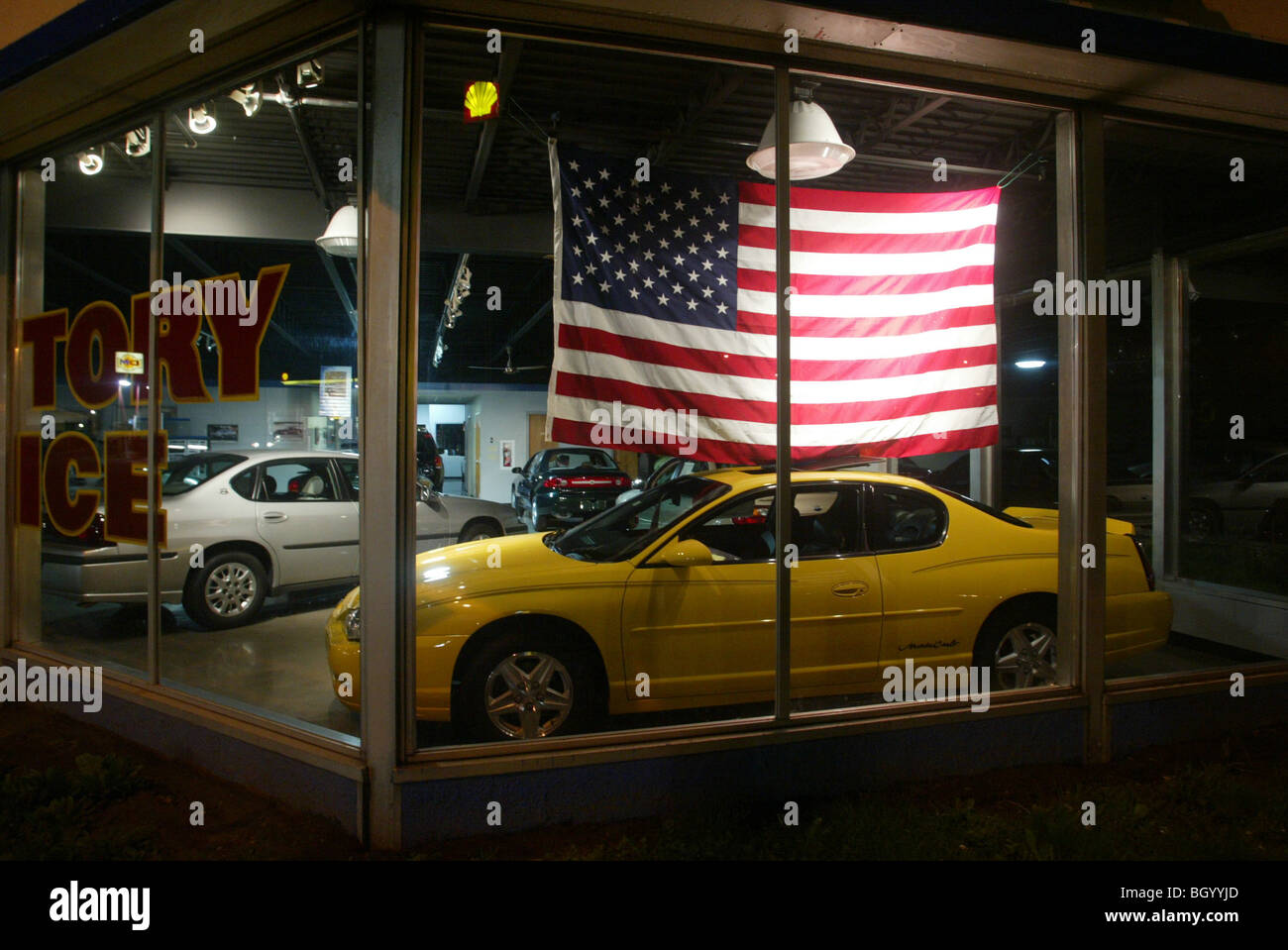 The American flag is used to help sell cars in Lawrenceburg, Indiana. night southern indiana ohio river town Stock Photo