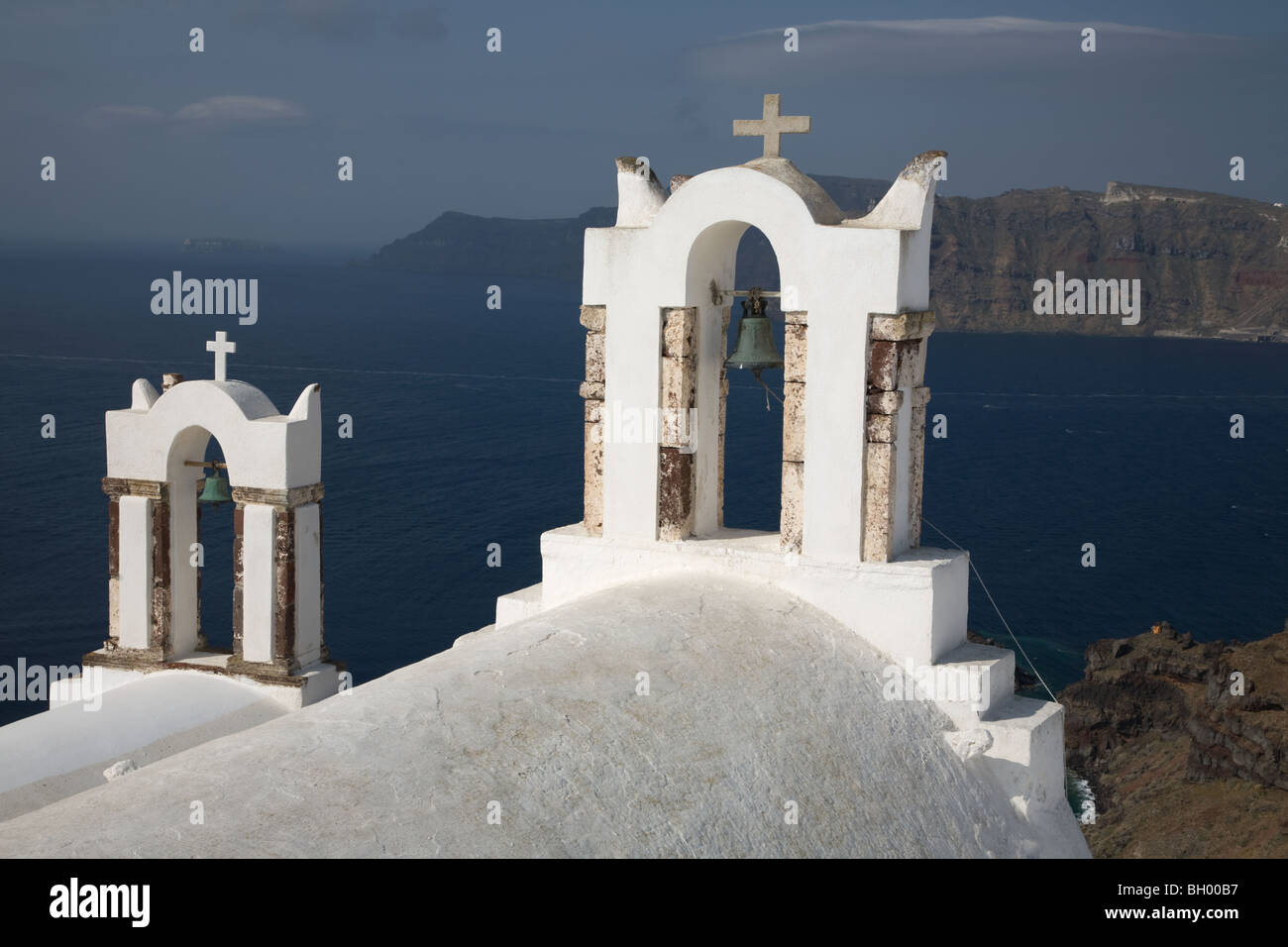 Church bell towers overlooking Santorini's caldera and lagoon in the Greek islands Stock Photo