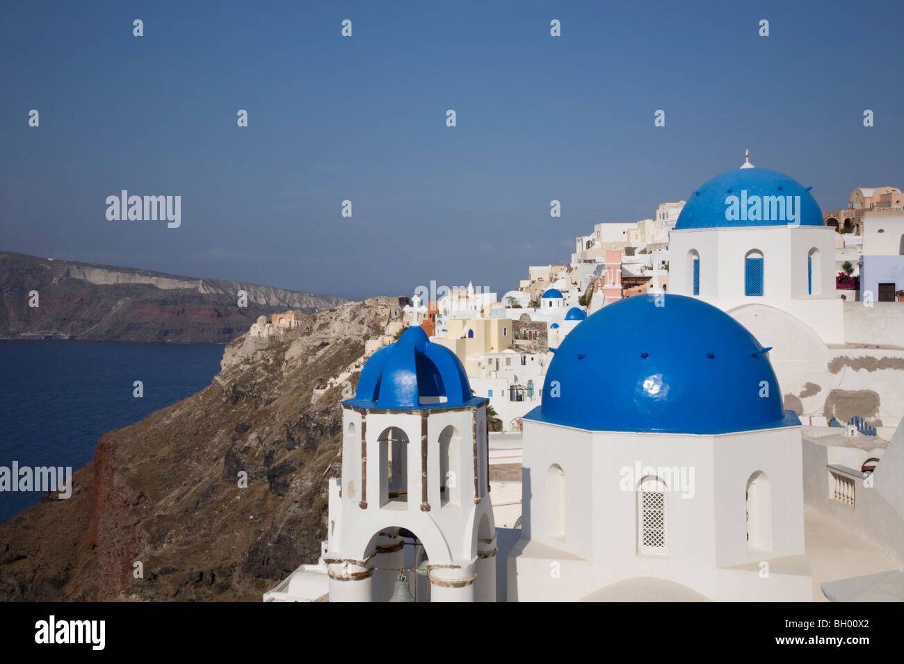 Clifftop Town Of Oia With Three Blue-domed White Churches Overlooking 