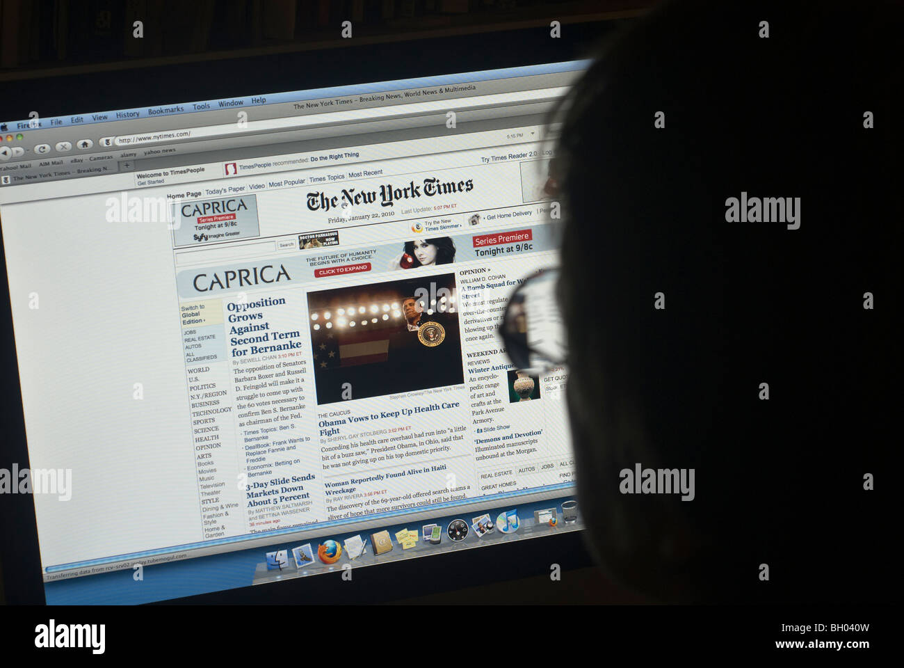 A reader peruses the New York Times website Stock Photo