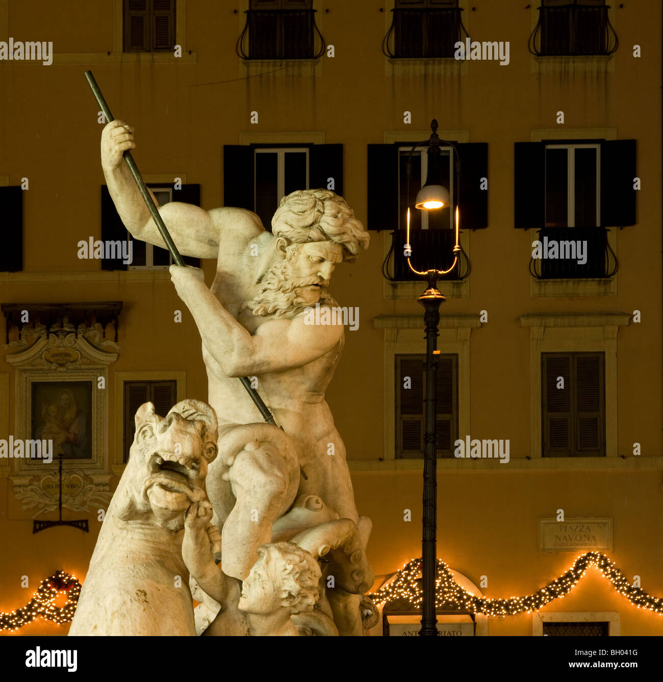 Night view of statues from Bernini's Fountain of Neptune (fontana di nettuno) in the Piazza Navona in Rome Italy Stock Photo