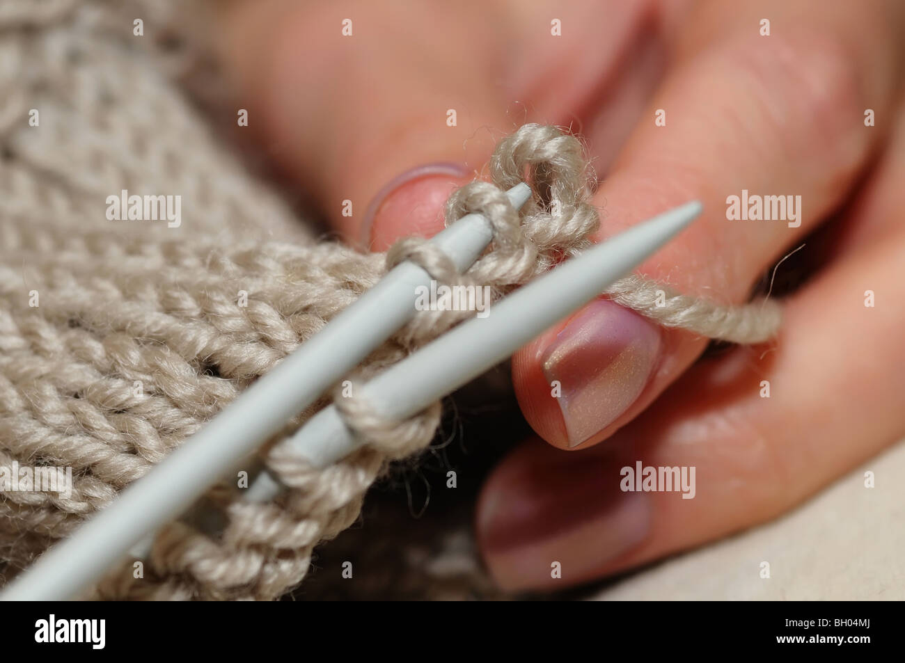 Hands of a young woman knitting socks Stock Photo