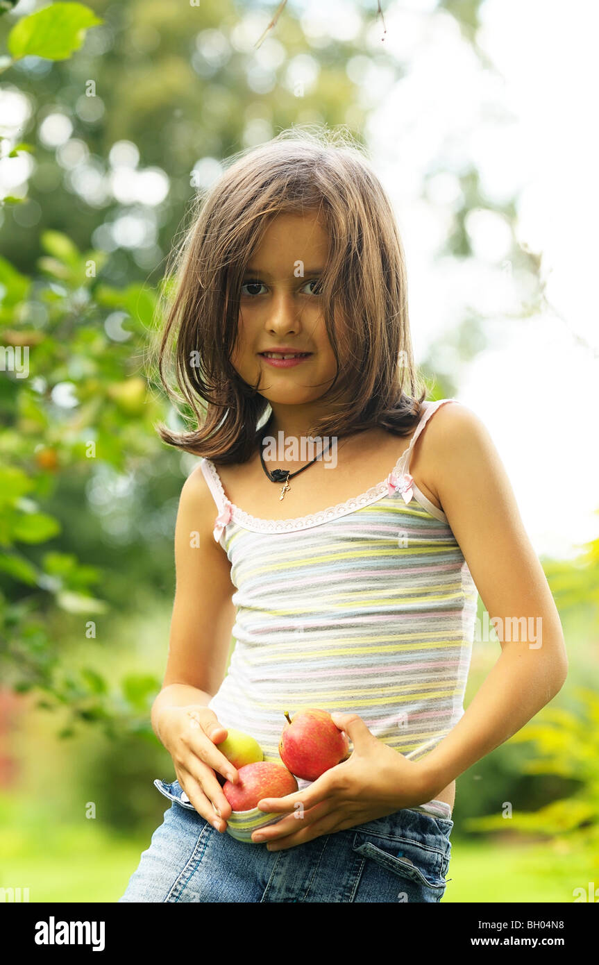 Girl with red apples in th garden Stock Photo