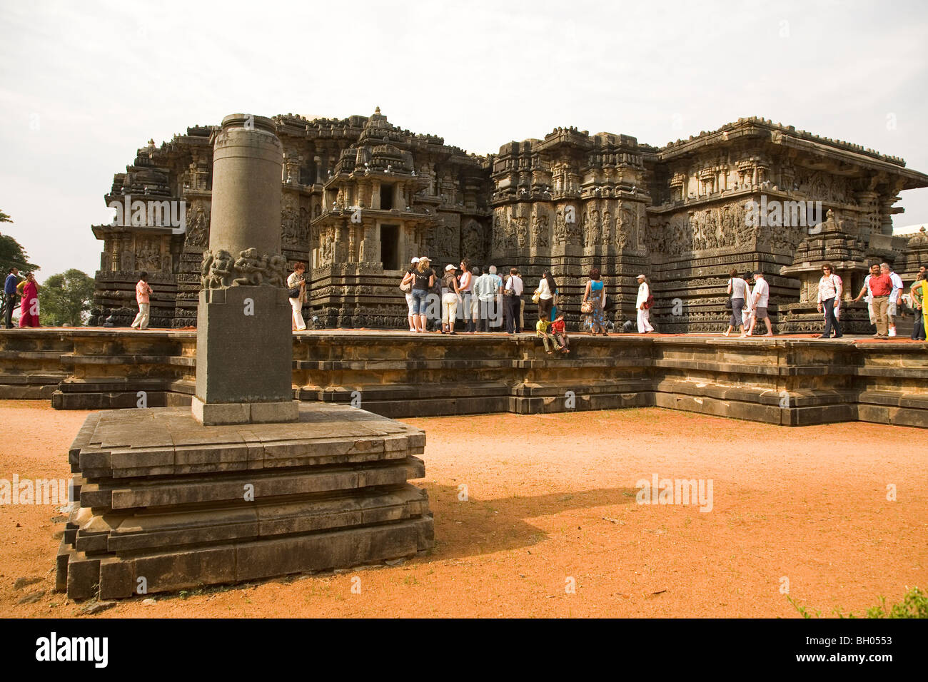 Tourists visit the Hoysaleshvara Temple at Halebid in Karnataka, India. Stock Photo
