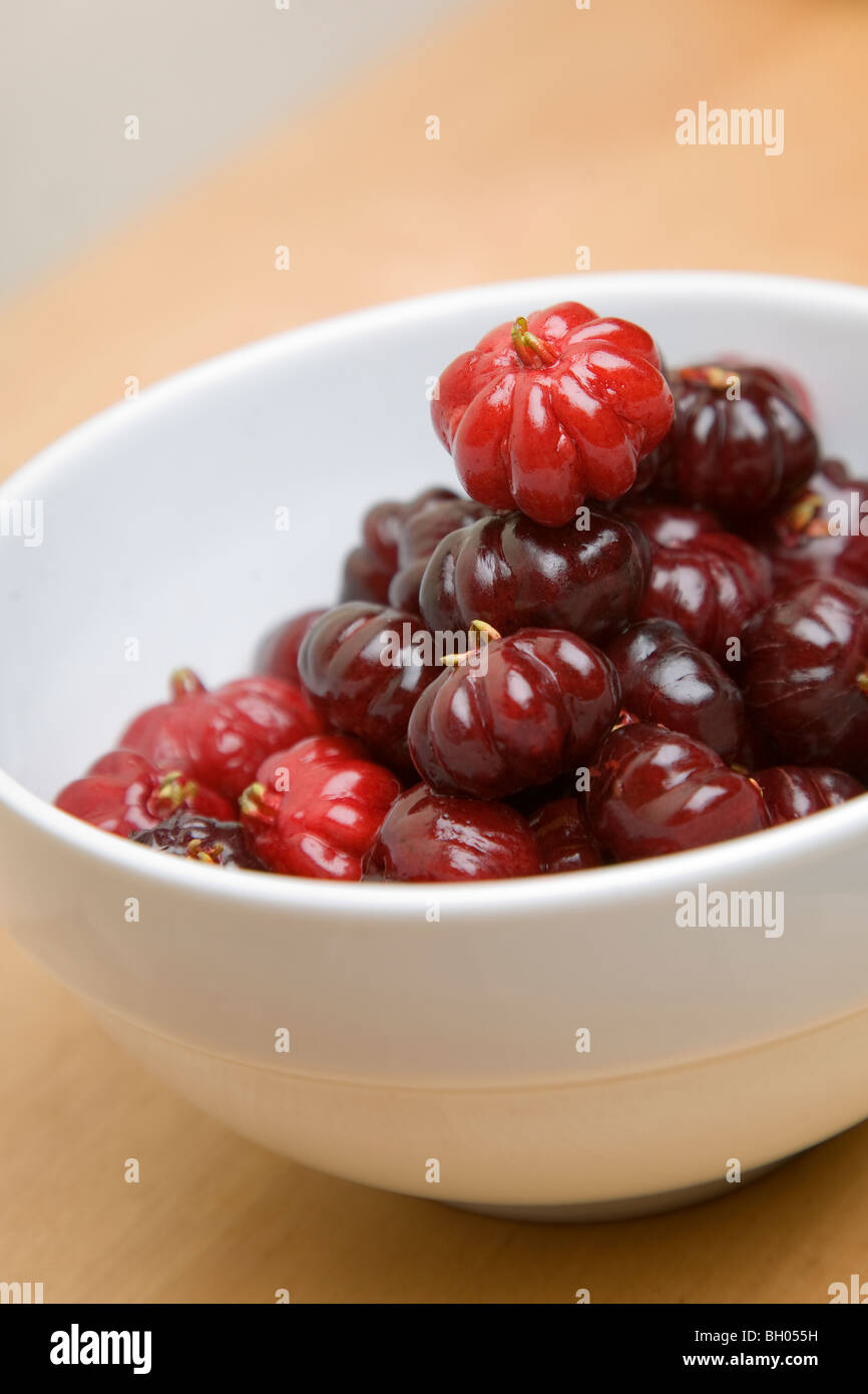 A bowl of pitangas or Surinam Cherries, the fruit from the Eugenia uniflora tree, Stock Photo