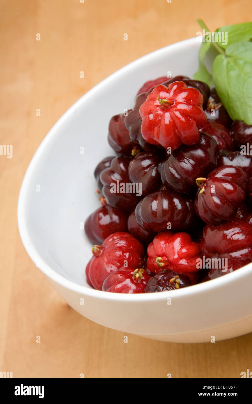 A bowl of pitangas or Surinam Cherries, the fruit from the Eugenia uniflora tree, Stock Photo