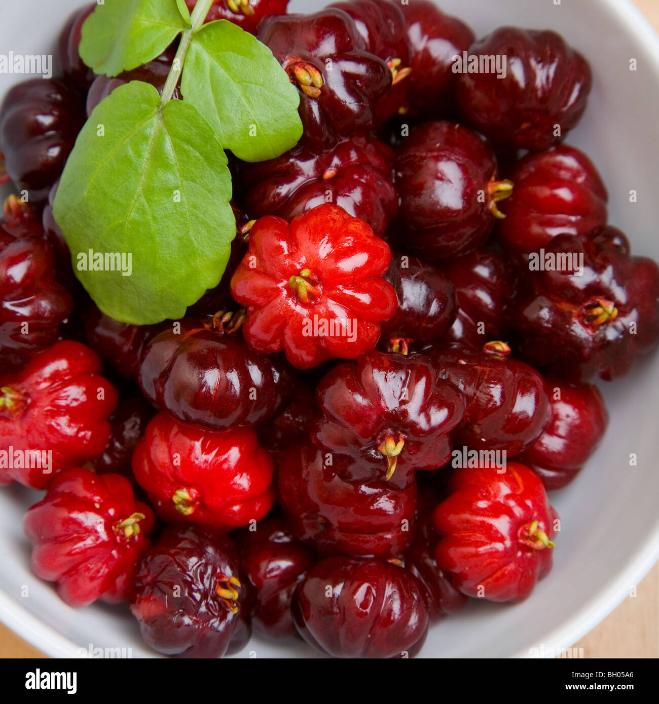 A bowl of pitangas or Surinam Cherries, the fruit from the Eugenia uniflora tree, Stock Photo