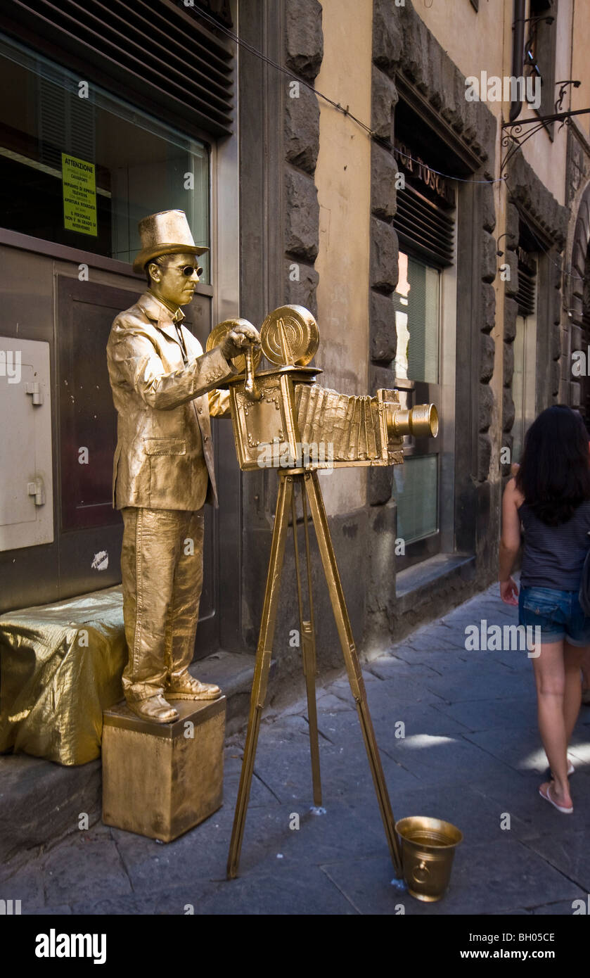 Gold Photographer Mime Artist Statue seen in Sienna Tuscany Italy Stock Photo