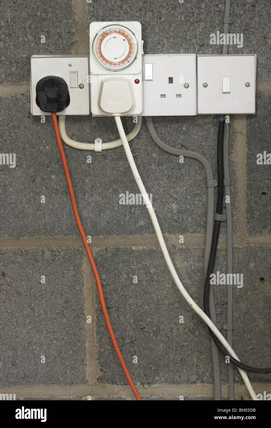Electrical sockets and plugs on a garage wall Stock Photo - Alamy