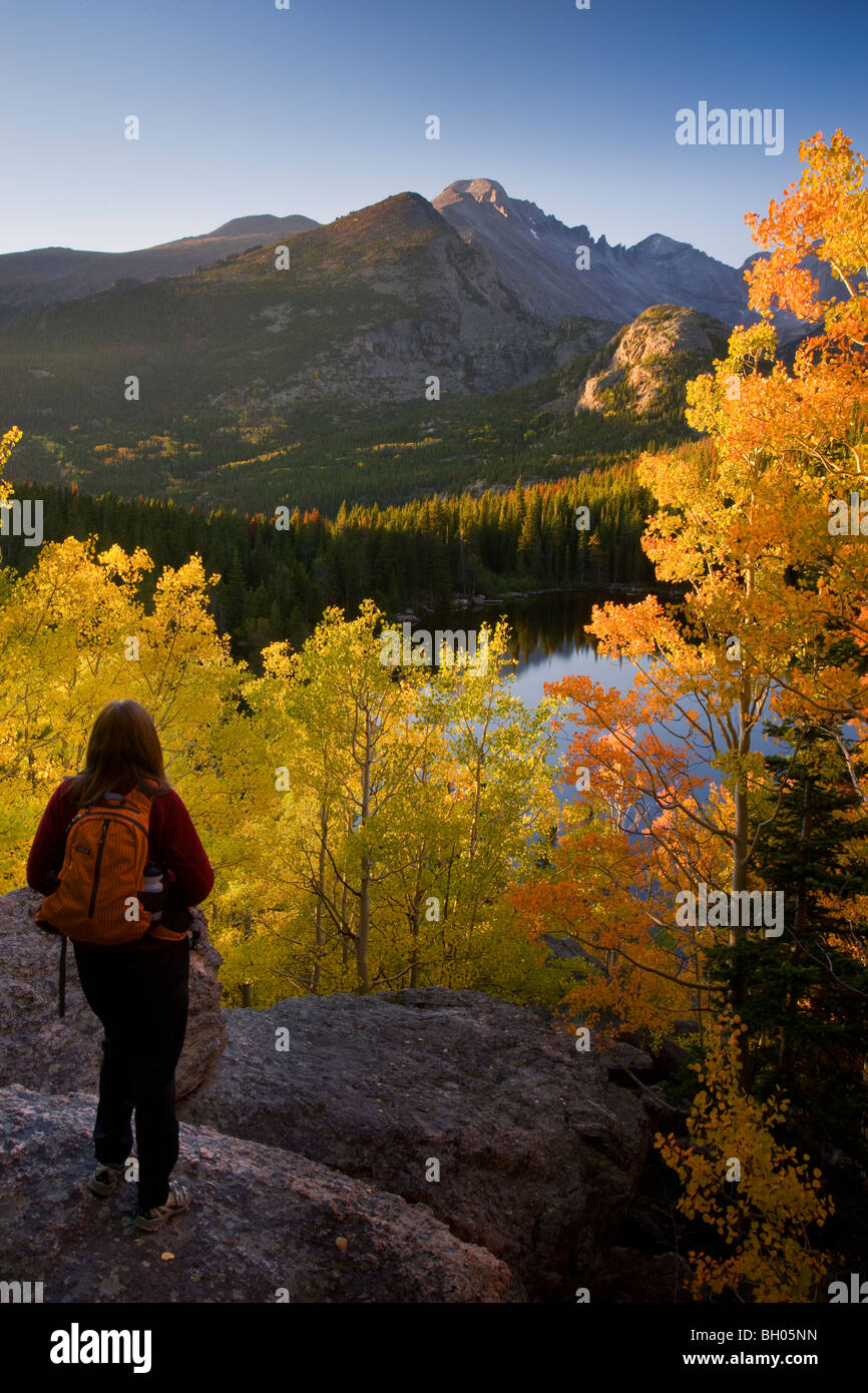A hiker enjoys the autumn colors at Bear Lake, Rocky Mountain National