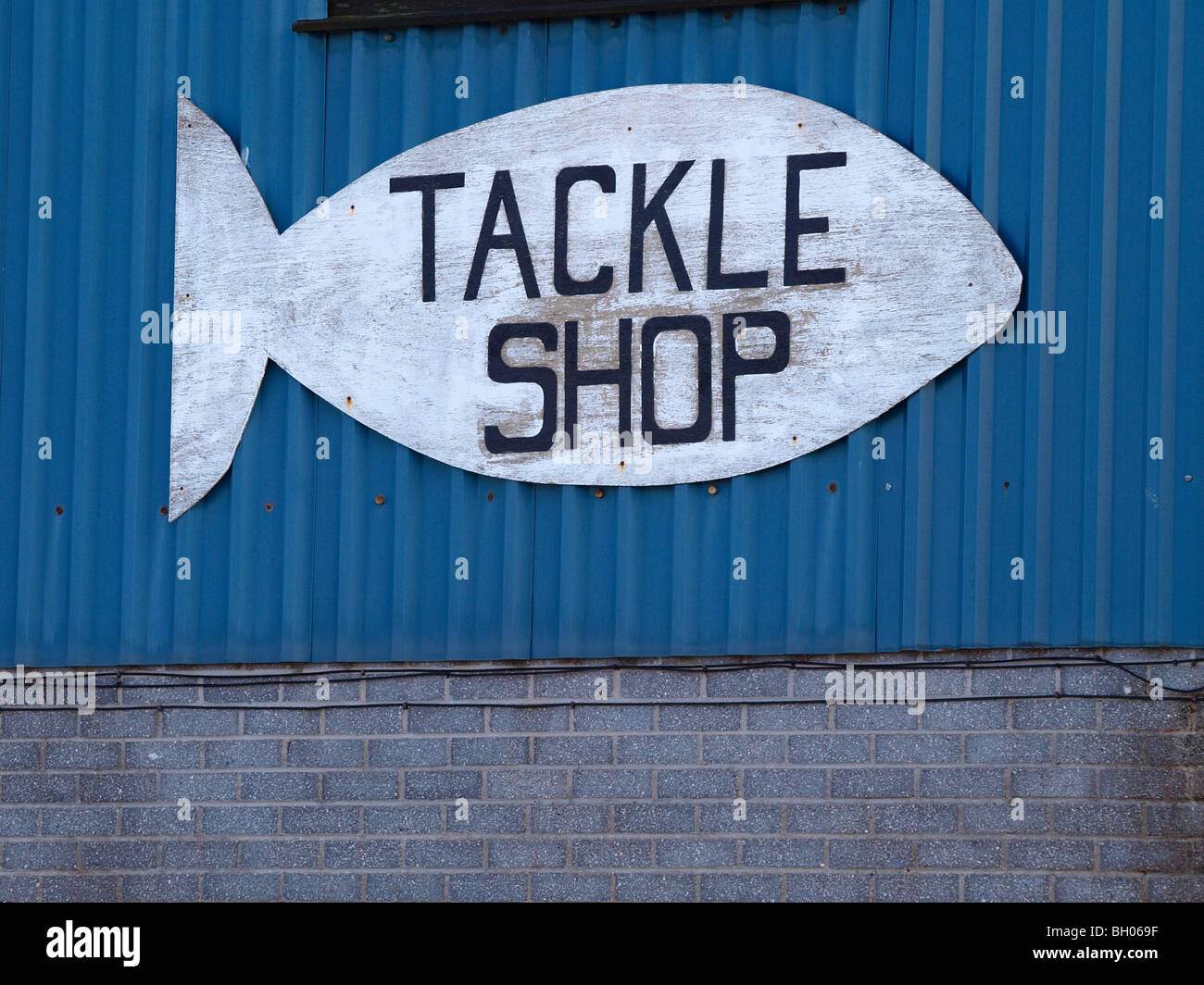 Tackle shop sign in the shape of a fish Stock Photo - Alamy