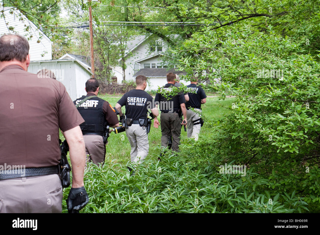 Sheriff's Office deputies serving drug related search warrant. Stock Photo