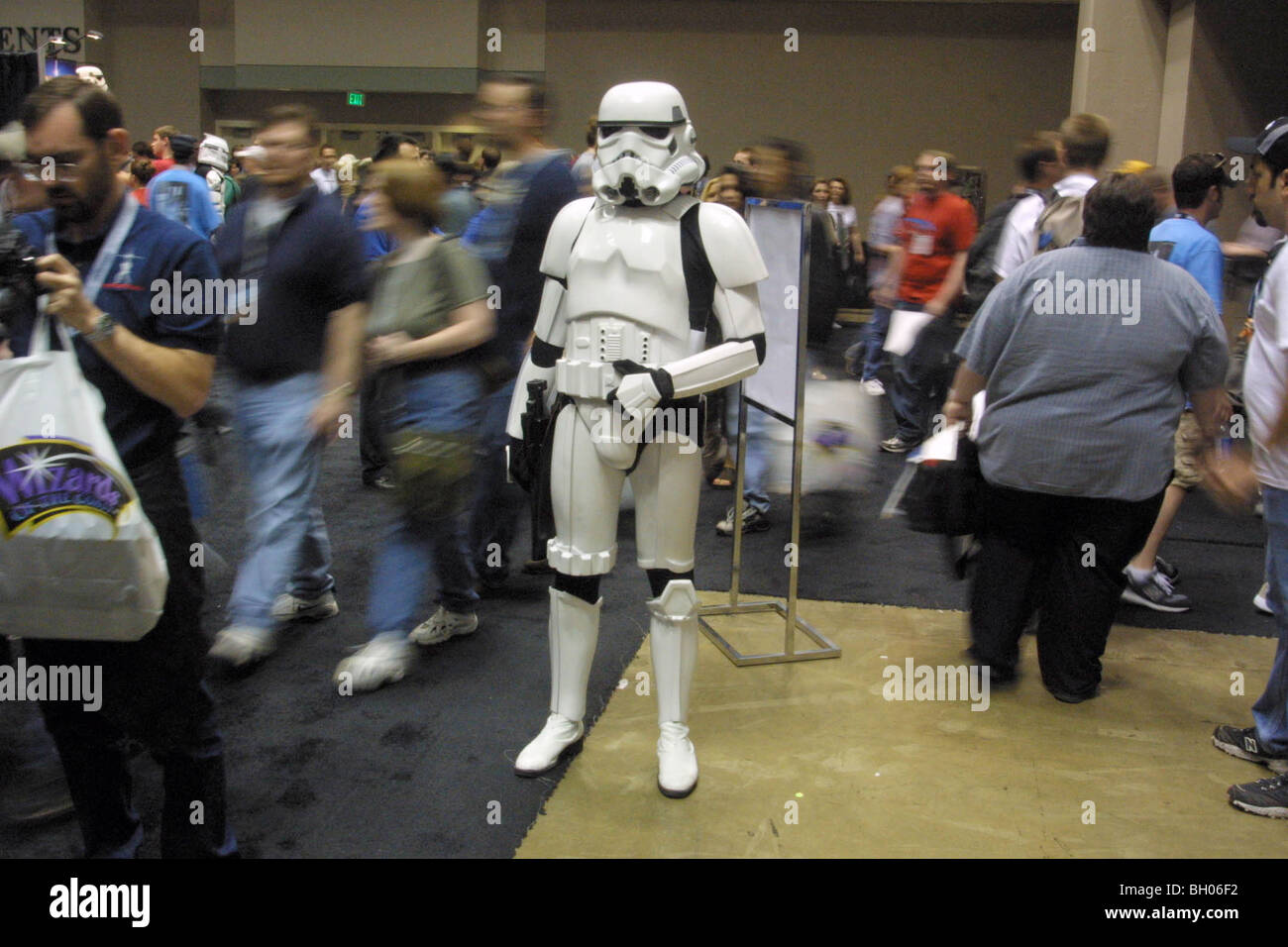 Convention attendees pass a standing Storm Trooper during Star Wars Celebration II in Indianapolis, Indiana. Stock Photo