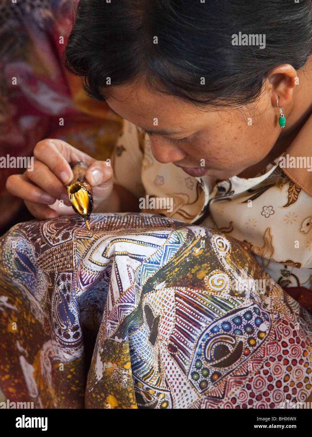 Batik craftwork, Bali. Applying hot wax 'resist' on fabric before selective dying Stock Photo