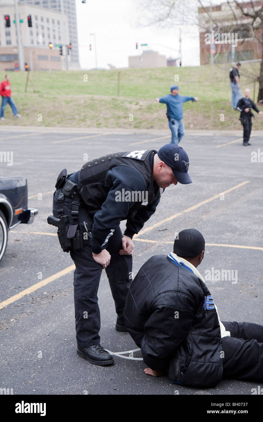 Police officers from the Tactical squad of the Street Narcotics Unit questioning suspect. Kansas City, MO, PD. Stock Photo