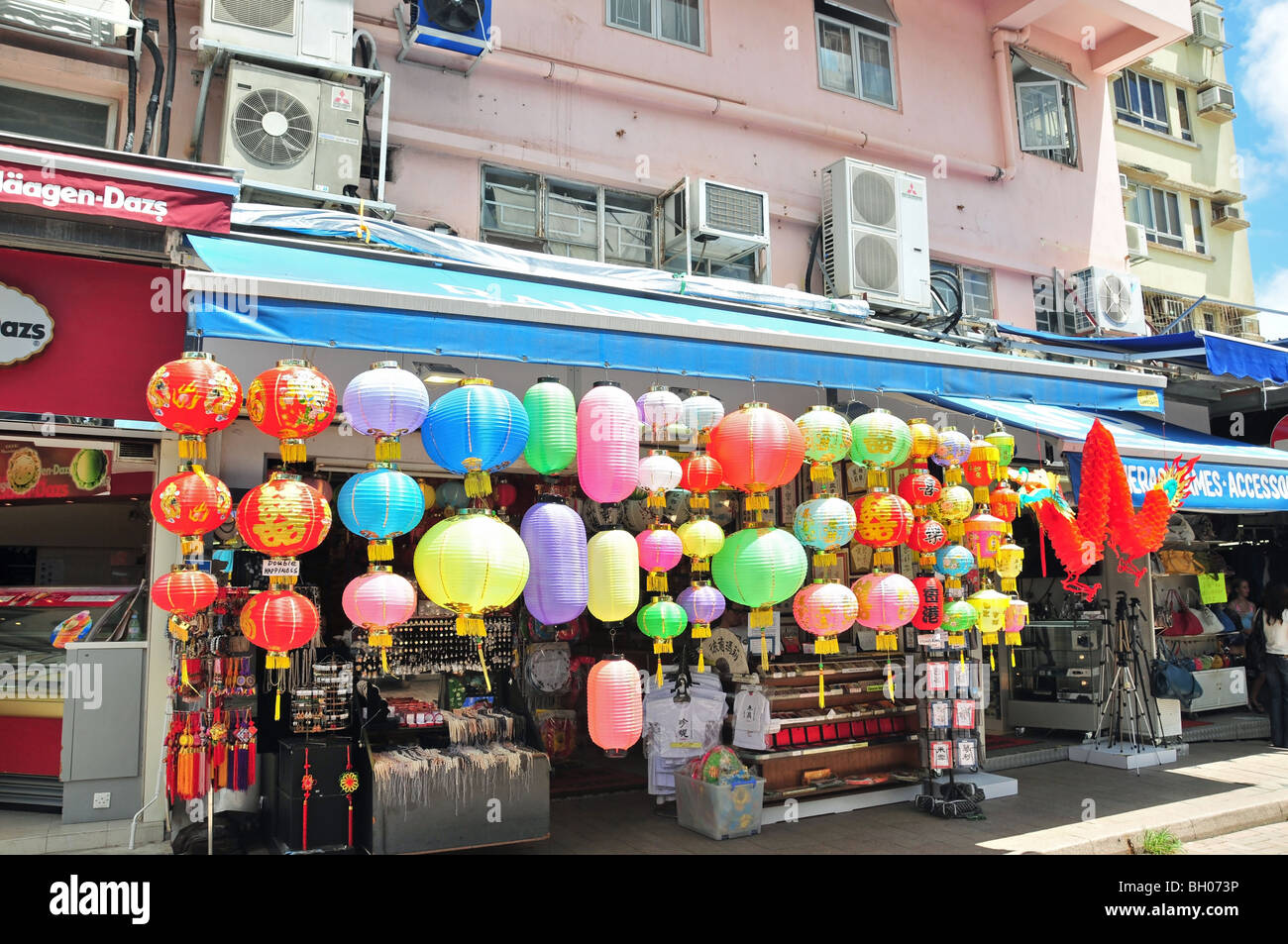 Coloured assortment of Chinese lanterns and red dragon hanging from a shop front in Stanley Market, Hong Kong, China Stock Photo